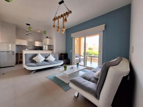 a living room with a couch and a table at El Gouna Waterside E 1-Bedroom Ground Floor Sleeps 4 Persons in Hurghada