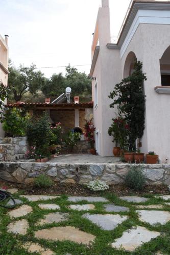 a house with a stone path in front of it at Goddesses Villa 1 in Nies in Soúrpi