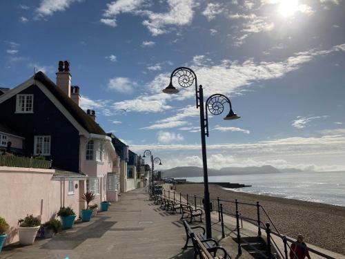 ein Straßenlicht auf einem Bürgersteig neben dem Strand in der Unterkunft Dolphin Cottage Lyme Regis in Lyme Regis