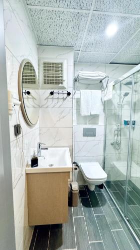 a bathroom with a sink and a toilet and a shower at Toprak City Hotel Antalya in Antalya