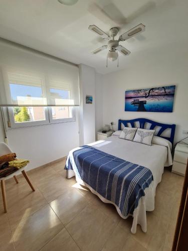 a bedroom with a bed and a ceiling fan at Oliva Moon in Oliva
