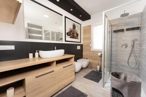 a bathroom with a sink and a toilet and a shower at Apartment Stella in Rabac