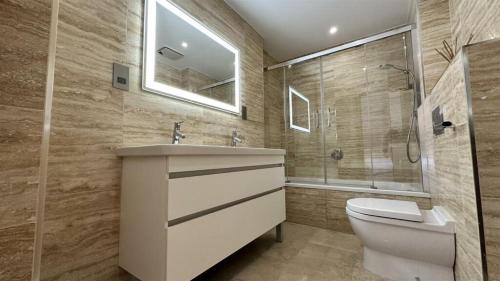 a bathroom with a toilet and a sink and a shower at Gibraltar Central Suites in Gibraltar