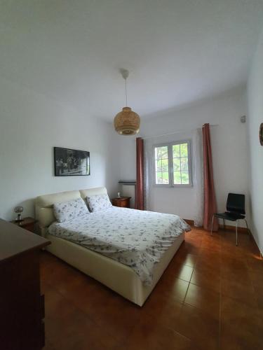 a bedroom with a large bed and a window at Il Giardino di Piero - LT-0029 in Salto