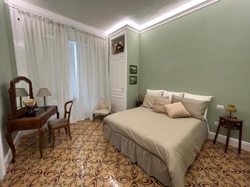 a bedroom with a bed and a desk and a chair at La Casa di Ilde Maison de charme et d art in Morcone