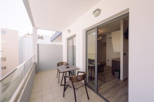 a balcony with a table and chairs in a building at Medusa Apartments in Rethymno Town