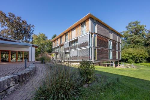 a large building with a lawn in front of it at Seehörnle Bio Hotel & Gasthaus in Gaienhofen