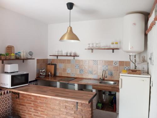 a kitchen with a sink and a counter top at Apartamento con acceso directo a la playa in Rincón de la Victoria
