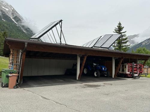 a garage with a solar roof on top of it at Haus am Waldrand in Leutasch