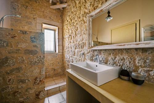 a bathroom with a sink and a mirror at Riglia Villas in Riglia
