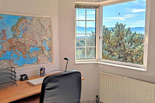an office with a desk and a map on the wall at Ecoscape Luxury Villa Lamia in Lamía
