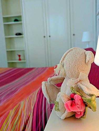 a stuffed teddy bear sitting on top of a bed at Ecoscape Luxury Villa Lamia in Lamía