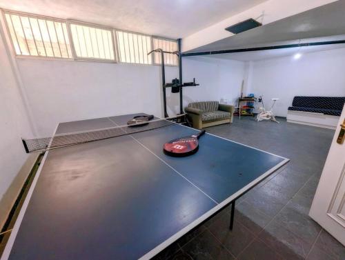 a ping pong table in a room with a ping pong ball on top at Ecoscape Luxury Villa Lamia in Lamía