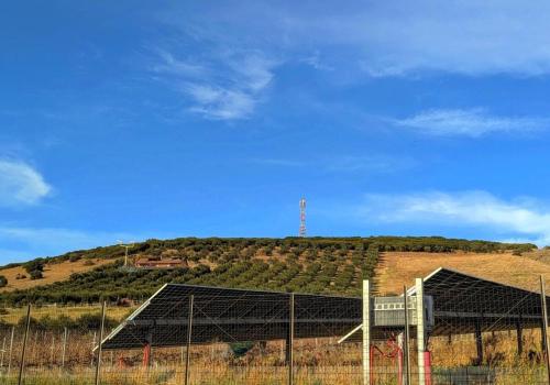 a field with a hill with a building on it at Ecoscape Luxury Villa Lamia in Lamía