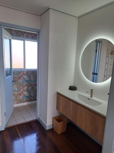 a bathroom with a sink and a mirror at Brisbane 1960s Pool House - hosted bed and breakfast in Brisbane