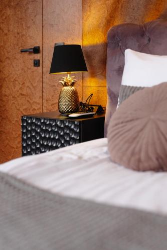 a bed with a pillow and a lamp on a table at GM Eco Bubble in Yablunytsya
