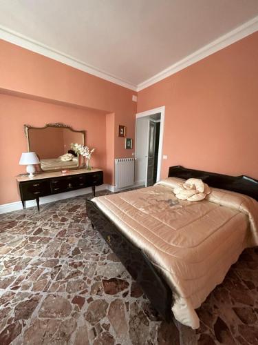 a bedroom with a large bed and a mirror at La Casa di Ilde Maison de charme et d art in Morcone