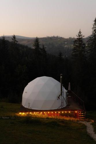 a large white tent in a field with lights at GM Eco Bubble in Yablunytsya