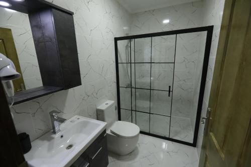 a bathroom with a toilet and a sink and a shower at Nu-se Garden Butik Otel in Selcuk