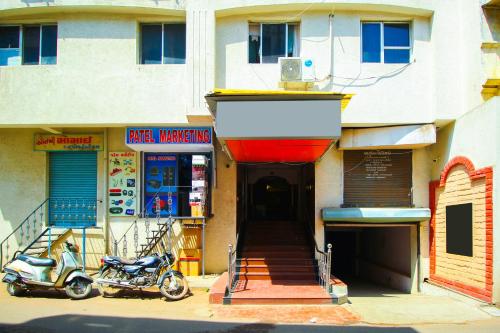 a scooter parked in front of a building at Hotel Upasana in Rajkot
