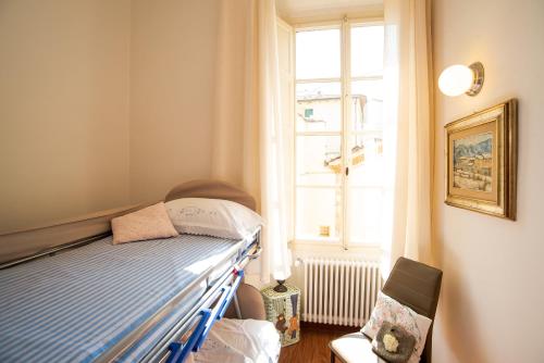 a small bedroom with a bed and a window at Il Canto De' Rossi Apartment in Pistoia