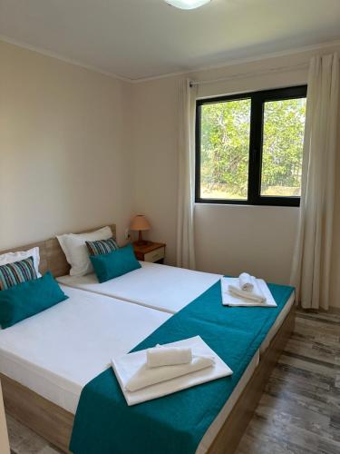 a bedroom with two beds with towels on them at Villa Sea House in Byala