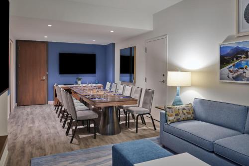 a dining room with a table and chairs and a couch at Walt Disney World Swan Reserve in Orlando