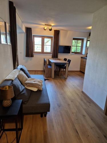 a living room with a couch and a table at Nicky apartments and studios in Niederau