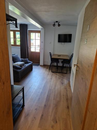 a living room with a couch and a table at Nicky apartments and studios in Niederau