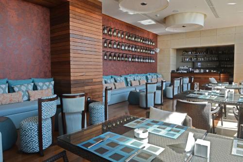 a restaurant with tables and chairs and a bar at Lancaster Plaza Beirut in Beirut