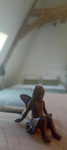 a small figurine of a frog sitting on a table at Les Bucoliques de la Noë in Goven