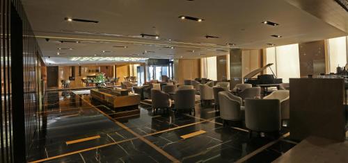 a conference room with chairs and a bar in a building at Lancaster Plaza Beirut in Beirut