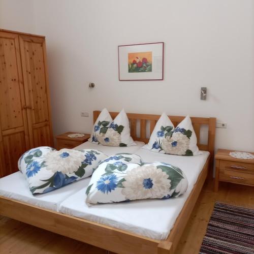 a bedroom with two beds with blue and white pillows at Ferienwohnung am Wirtlerhof in Wildermieming