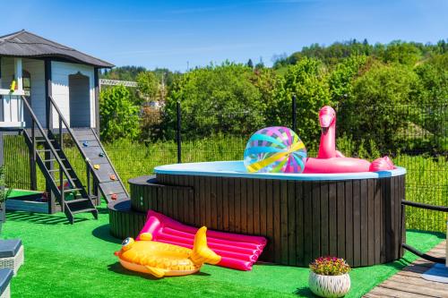 a childs play area with a pool and a slide at GORSKI RESORT Lux Apartments Jacuzzi & Sauna in Poronin