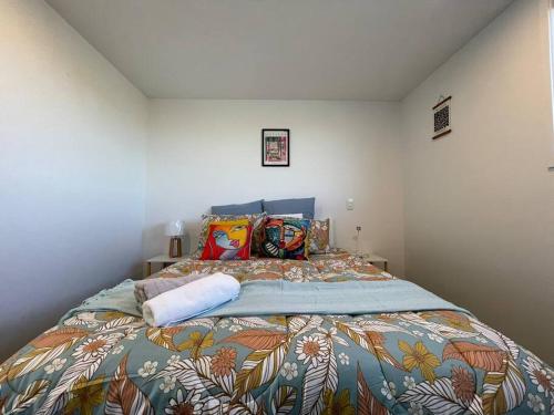 a bedroom with a large bed with a colorful blanket at CBD 2 Bedroom Parkside Living By Hagley with Free Parking in Christchurch