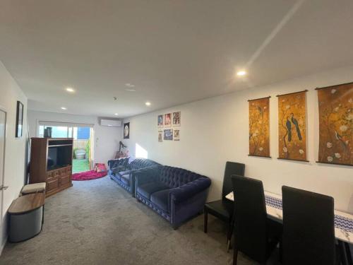 a living room with a couch and a tv at CBD 2 Bedroom Parkside Living By Hagley with Free Parking in Christchurch