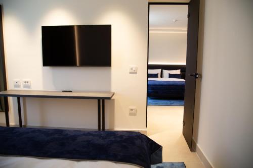 a bedroom with a table and a mirror and a bed at Abi's Hotel & SPA Vlore in Vlorë