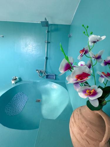 a bathroom with a vase with flowers in it at Sotiria's House in Lakkíon