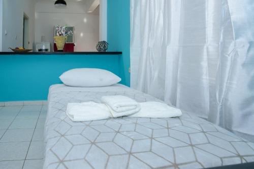 a bed with two towels on top of it at Sotiria's House in Lakkíon
