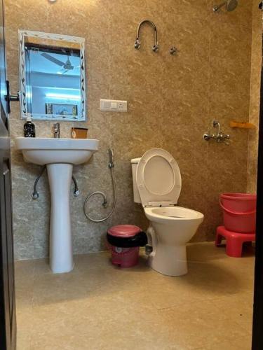 a bathroom with a toilet and a sink at Homestay-a better living in Lucknow