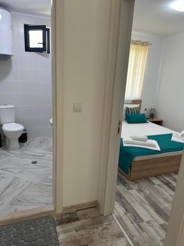 a bedroom with a bed and a bathroom with a toilet at Villa Sea House 2 in Byala
