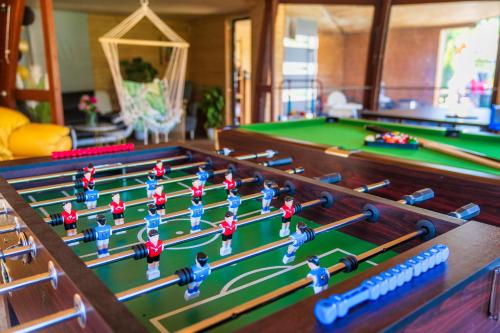 a model of a pool table with toy figures on it at GORSKI RESORT Lux Apartments Jacuzzi & Sauna in Poronin