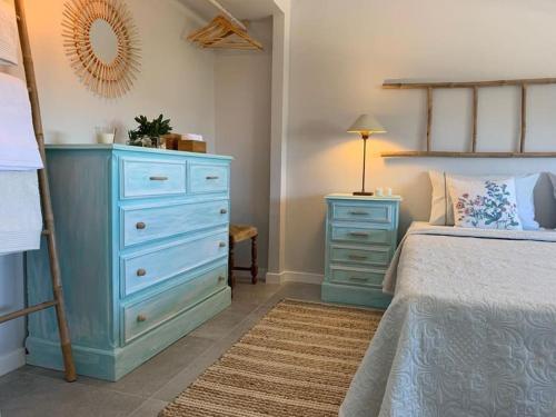 a bedroom with a blue dresser and a bed at Villa MariSol Ferragudo by Rosado in Ferragudo