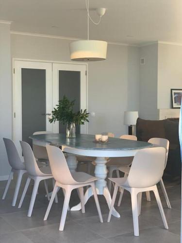 a dining room table and chairs with a table and a plant at Villa MariSol Ferragudo by Rosado in Ferragudo