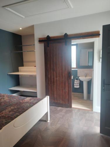 a bedroom with a door leading to a bathroom at Teachín in Killarney