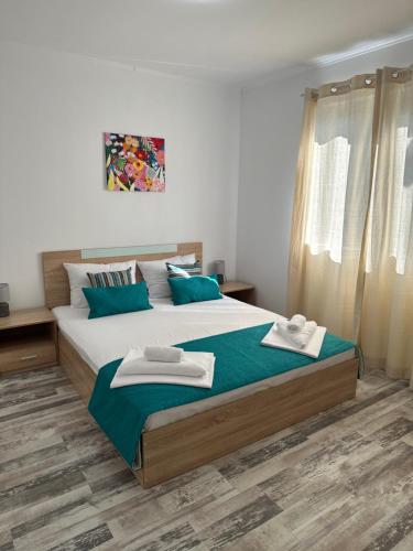 a bedroom with a large bed with two towels on it at Villa Sea House 3 in Byala