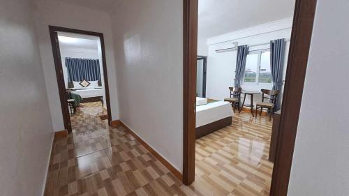 a room with a bedroom with a bed and a dining room at Family Transit Hotel Nội Bài in Hanoi