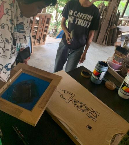 a man standing next to a table with a box at Seree Bungalows & Chill Bar in Ko Chang