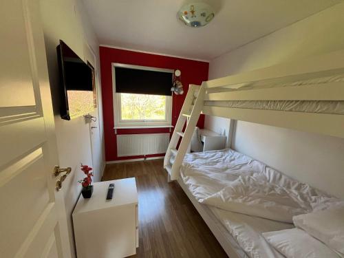 a bedroom with two bunk beds and a door at Slottshuset in Borgholm