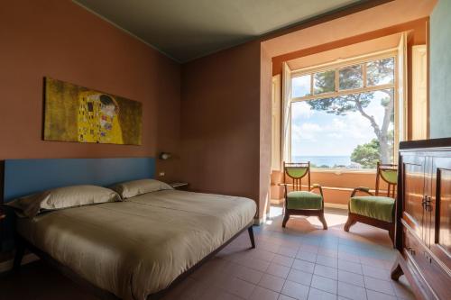 a bedroom with a bed and a window at Villa Rappis in Imperia